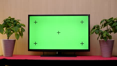 tv with green screen composited. tv or television - green screen - room - on the table.