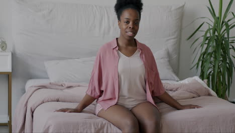 woman sitting on a bed