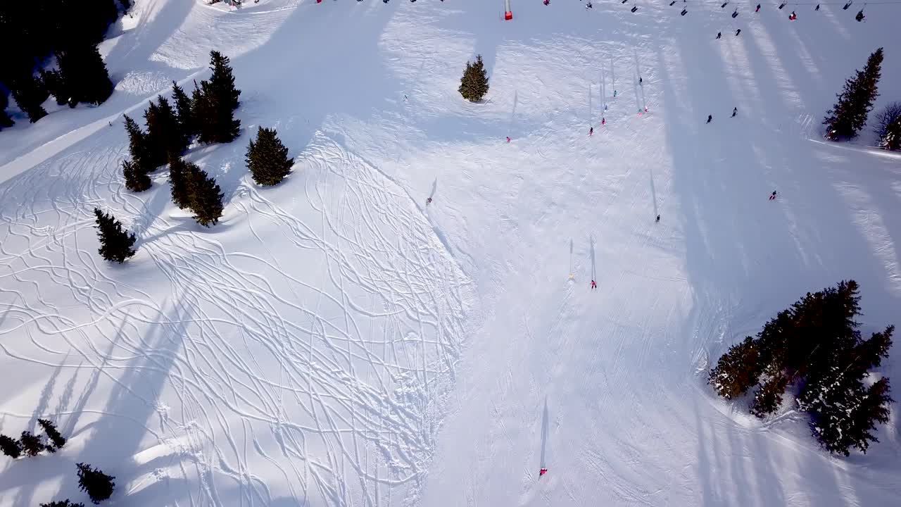 Aerial view of ski resort with people snowboarding down the hill