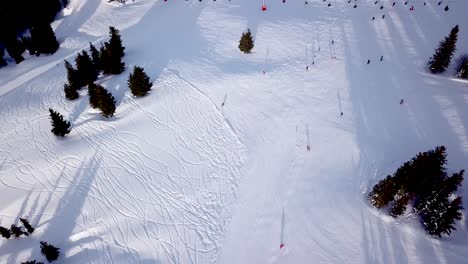 aerial view of ski resort with people snowboarding down the hill