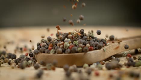 mixed peppercorns in a super slow motion. dry mix peppercorns close up.