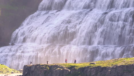 tourists at majestic dynjandi waterfall