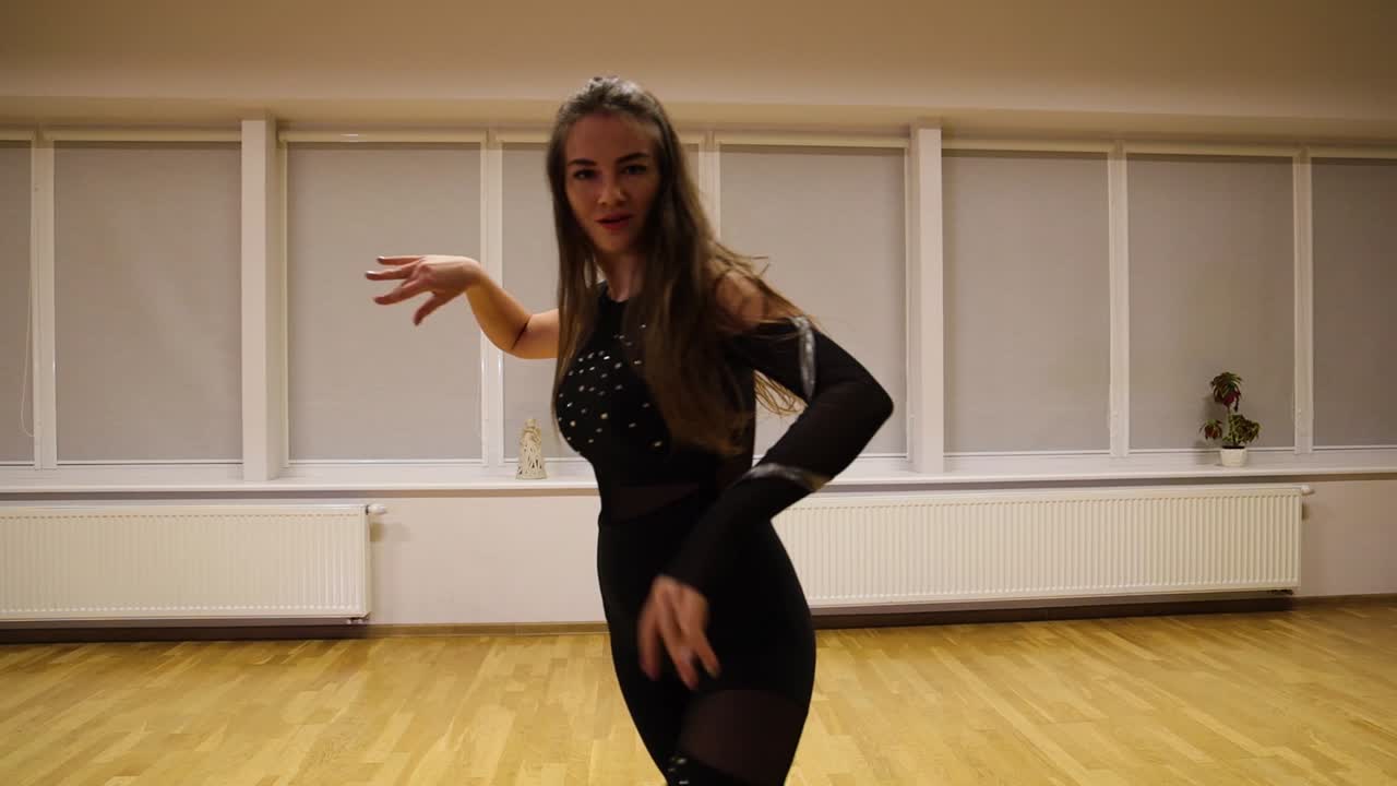 Talented young woman practicing contemporary dance moves to improve her technique