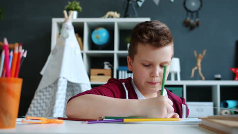 boy coloring at desk