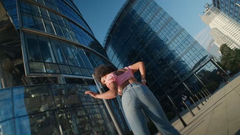 young woman posing in front of modern buildings