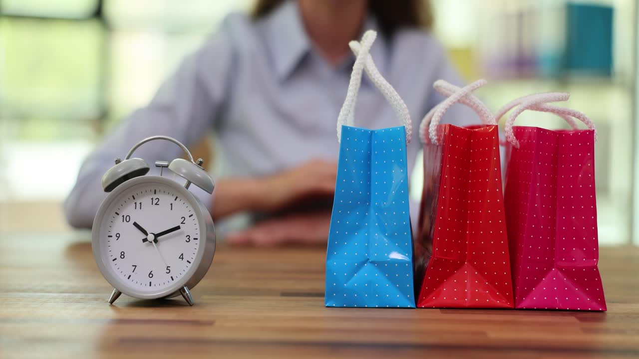 Shopping deadline with an alarm clock and gift bags