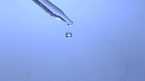 droplet falling off a pipette in super slow motion