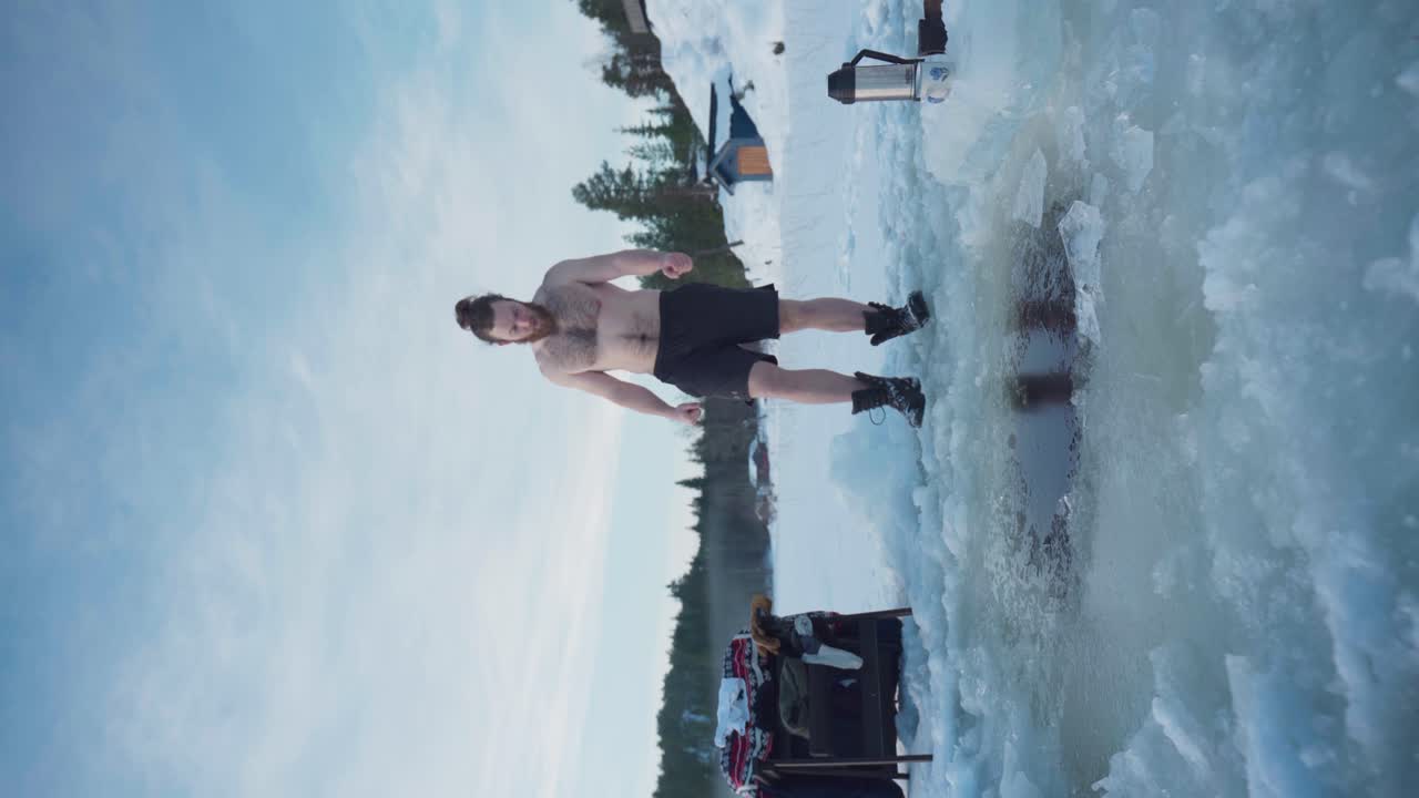 노르웨이 남자 의 수직 뷰 는 구 ⁇  이 있는 얼어붙은 호수 에 몸 을 담그는 것