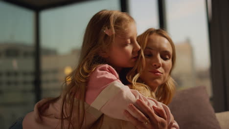 mother and daughter hugging at home