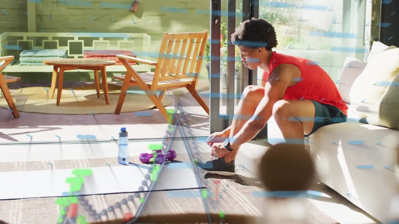 Animation of graphs over african american man tying sport shoes