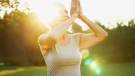 woman meditating in nature during sunrise