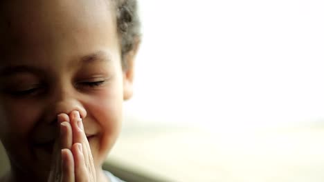 little-boy-praying-to-God-with-hands-together-on-white-background-with-people-stock-video-stock-footage