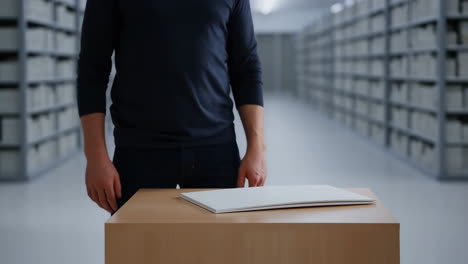 man standing in a modern archive or storage facility