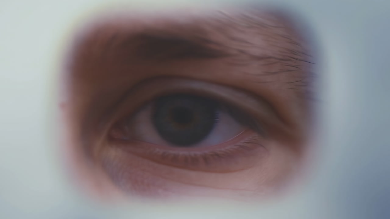 Intense Surgical Gaze Through Face Mask, Closeup Eye And Eyebrow Framed By Sterile Visor Conveys Concentration