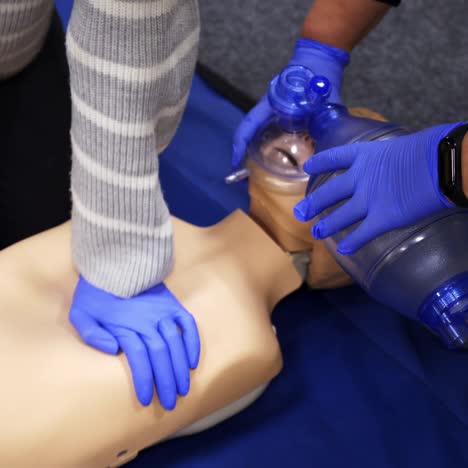 training on a medical dummy. people giving first aid on a mannequin for cardiopulmonary reanimation. demonstrating chest compression on a manikin.