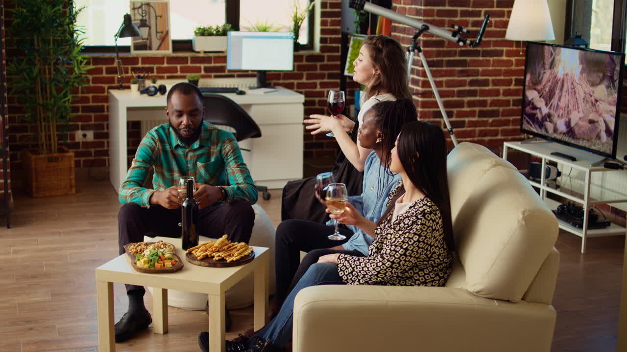 Happy colleagues throwing apartment party, drinking alcoholic beverages