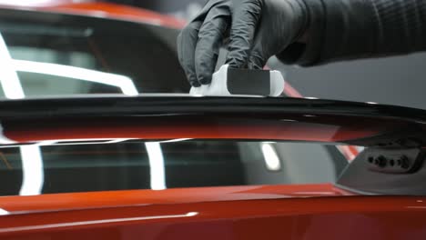 worker applying ceramic coating on car - close up, slow motion