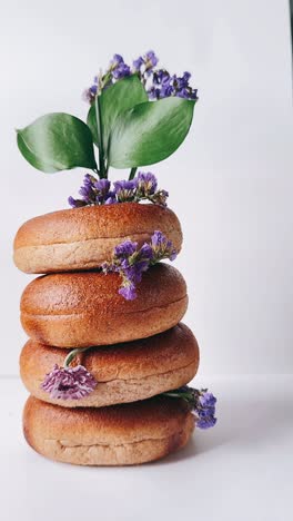 stack of bagels with purple flowers