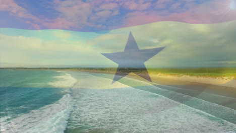 digital composition of waving ghana flag against aerial view of the beach