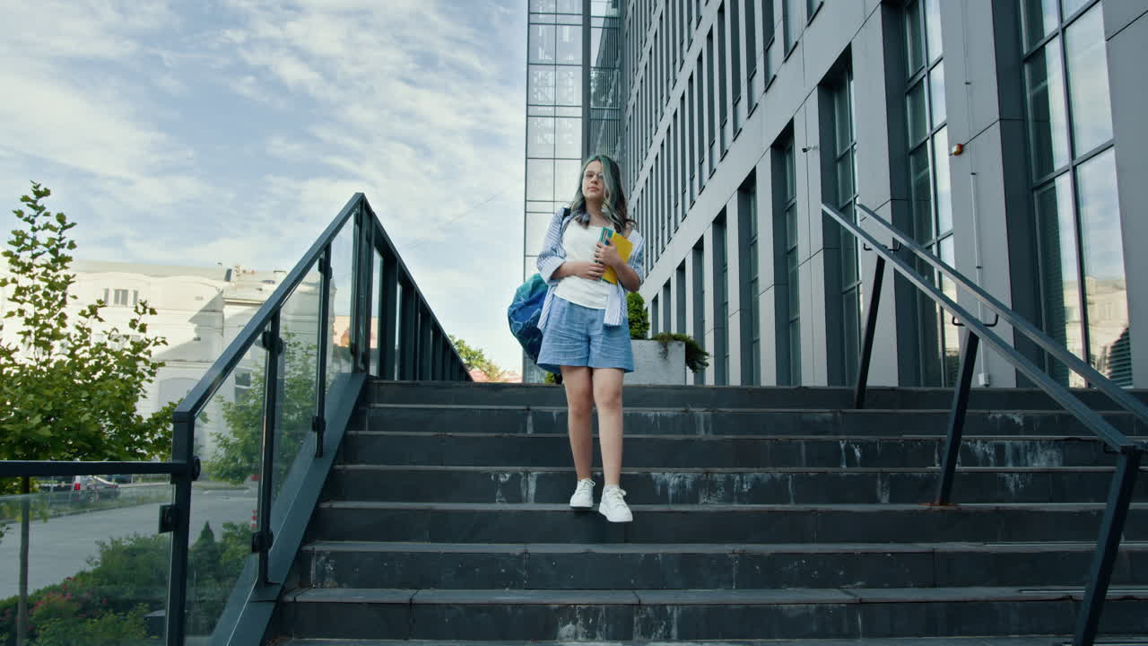 Teenagepige går op ad trappen til skole