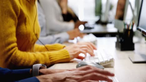 Customer-service-executives-talking-on-headset-at-desk-4k