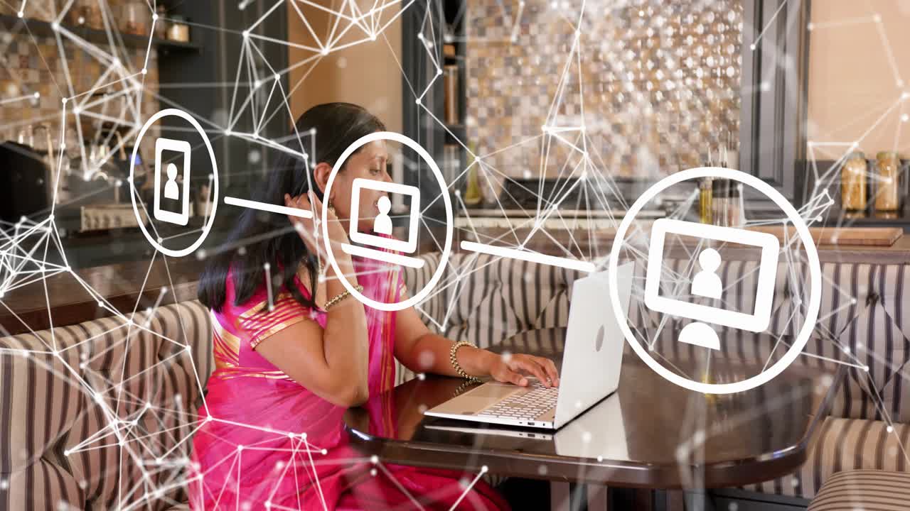Mature woman typing on laptop in cafe, activating network icons over scene, joining online meeting