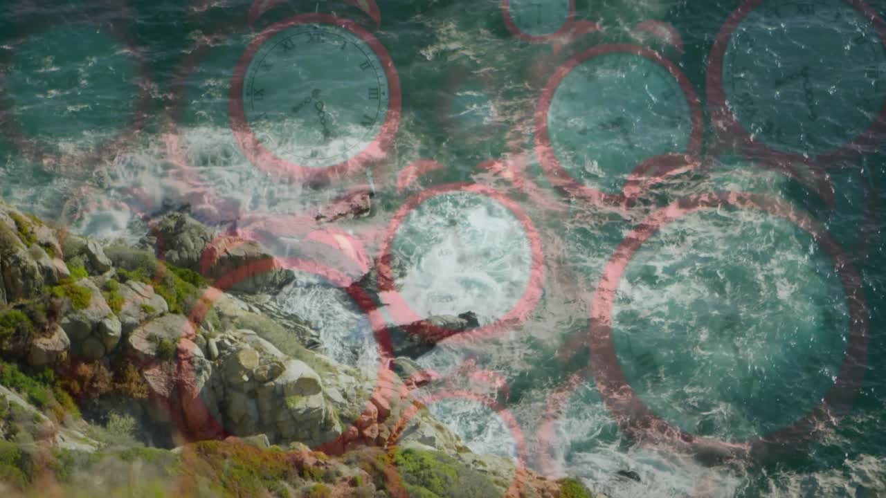 Red circular grid appearing, rocky shore, rolling ocean waves crashing, illustrating shore dynamics