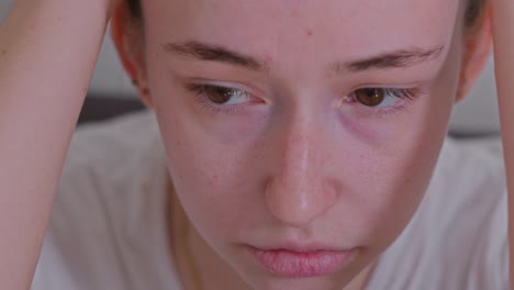 closeup of sad caucasian woman's face feeling pain.