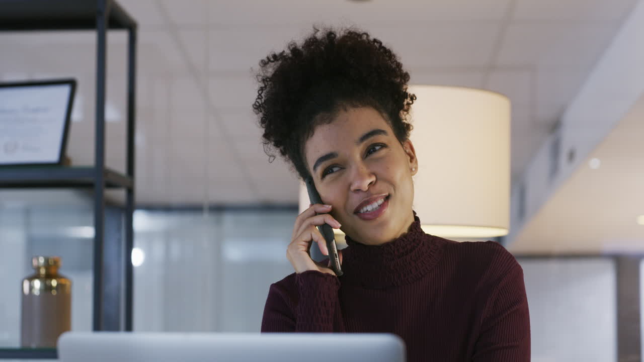 Happy Woman on Phone Call in Modern Office
