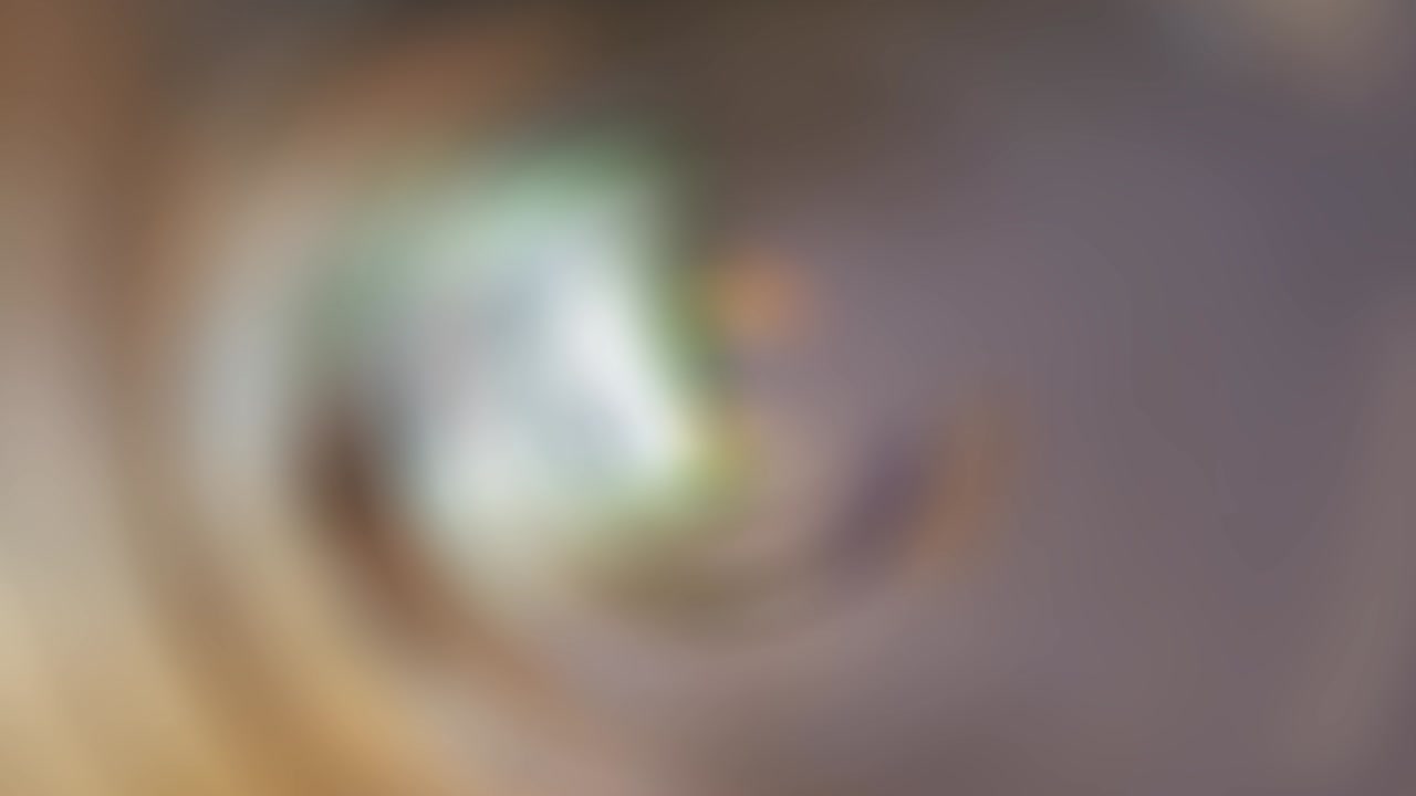 Abstract blurred brownish green background with spin effect, loop, 4k footage
