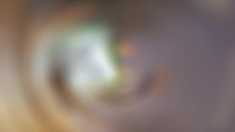 abstract blurred brownish green background with spin effect, loop, 4k footage