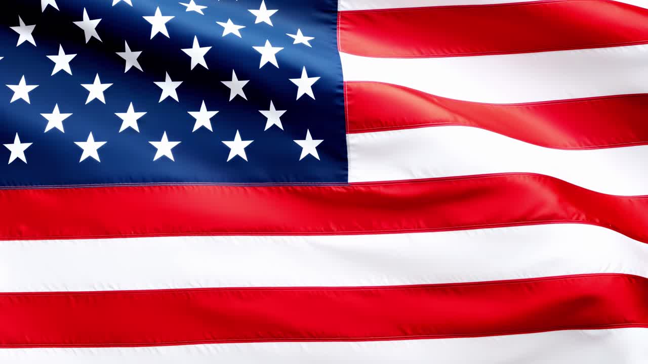 Close-up video shot of the American flag waving, capturing the vibrant red, white, and blue colors