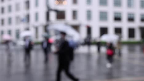 walking people on the street in marunouchi tokyo rainy day