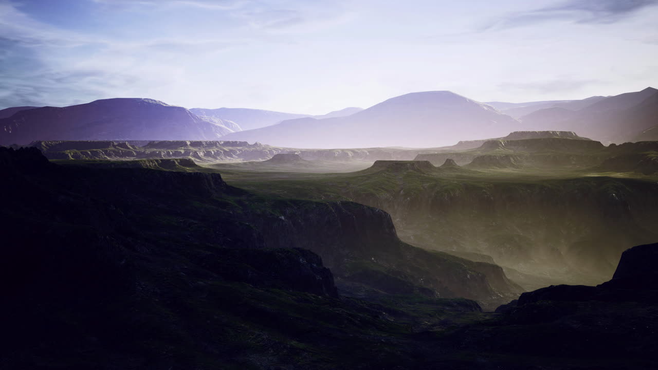 Majestic mountain landscape at dusk with mist and distant peaks in view