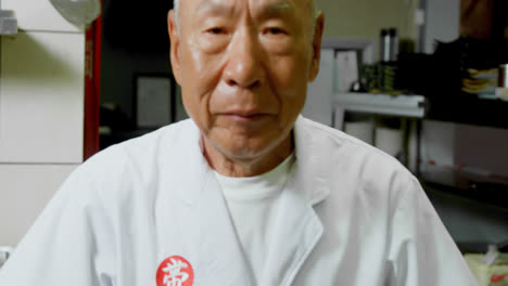 male chef standing in kitchen 4k