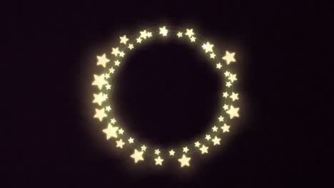 yellow glowing star shaped decorative fairy lights against black background