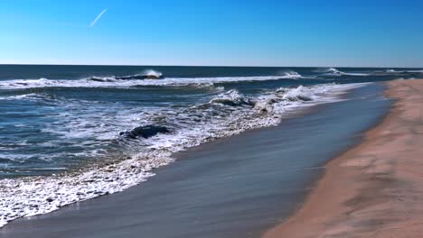 a low angle perspective of an empty beach on a sunny day