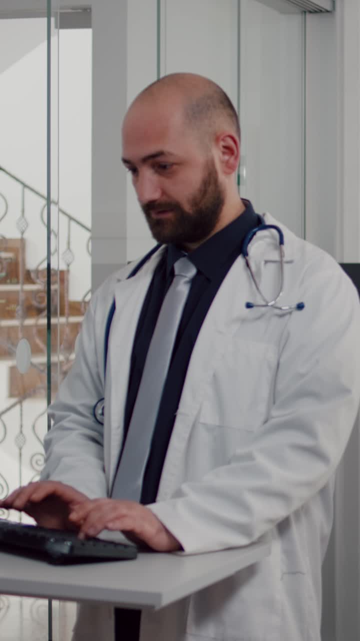 Vertical video: Doctor practitioner in uniform analyzing disease diagnosis typing illness treatment