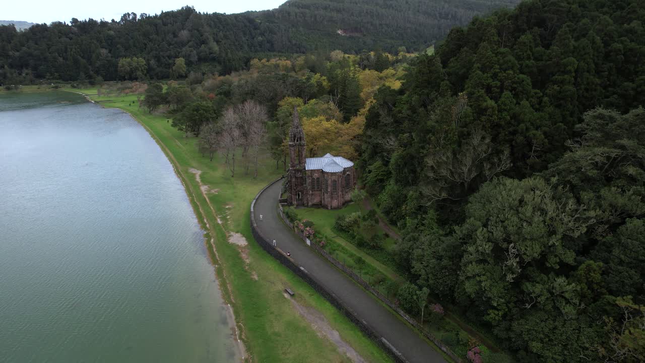 Capela de Nossa Senhora das Victorias revealed from above with nearby lake and forest near Furnas on Sao Miguel island in the Azores