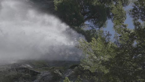 a slow motion close up of a beautiful waterfall with water cascading down a mountain in patagonia, argentina