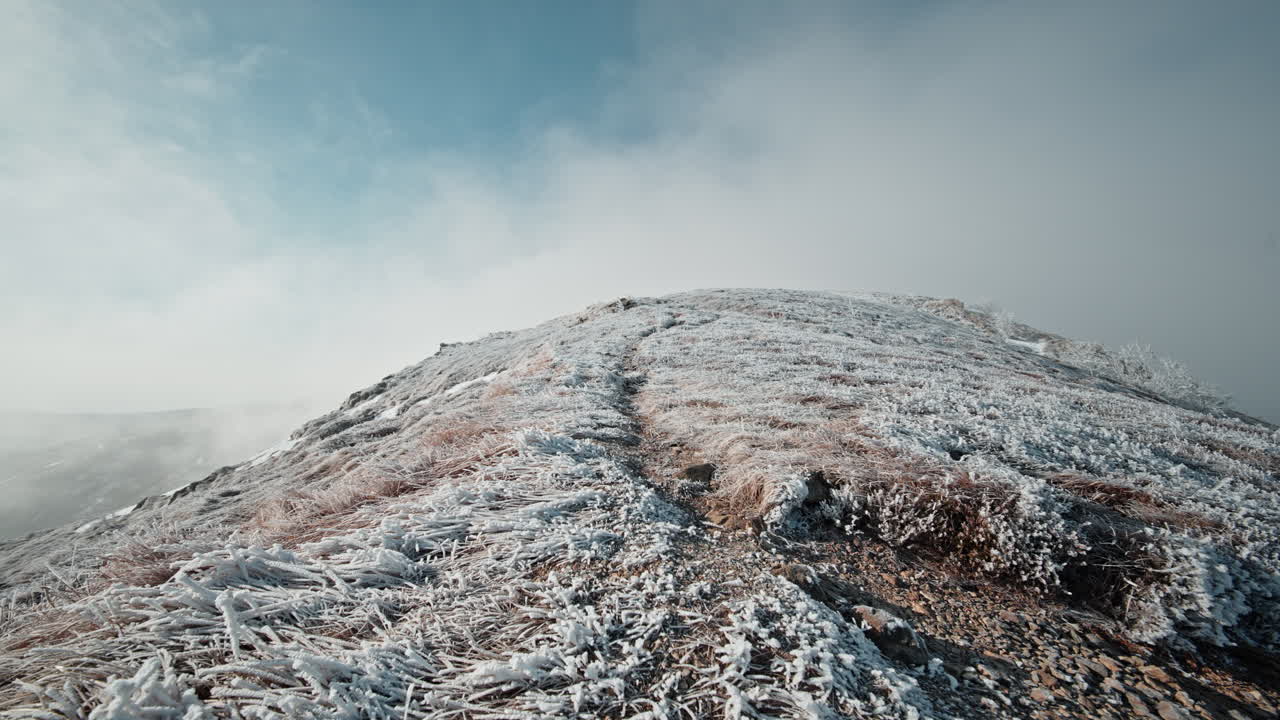 Snow-covered mountain trail in a timelapse, peaceful and serene winter atmosphere