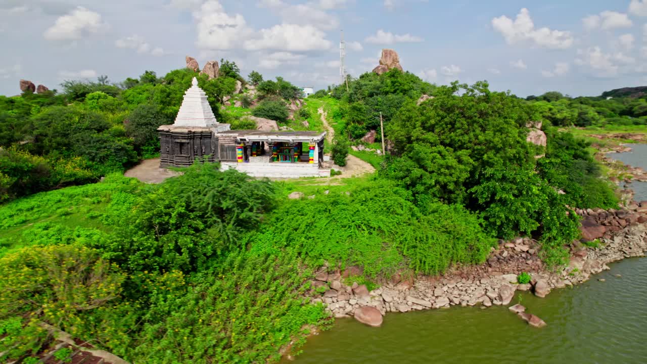 Thumbureshwara Temple with trees, and clouds at yelupu Gonda, Surampally, tekmal, Telangana, india. day time, semi orbit, drone shot, 4k.