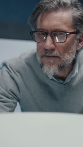 close-up of a man working on a laptop
