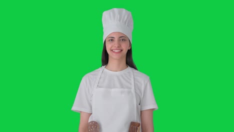 mujer india feliz chef profesional sonriendo pantalla verde