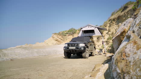 A-camper-car-parked-by-the-water-on-a-beach-in-Albania