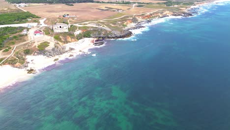 aerial-view-of-rugged-coast-line-with-blue-ocean-and-waves-crashing,-portugal,-4k