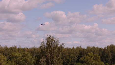 helicopter flying over a forest