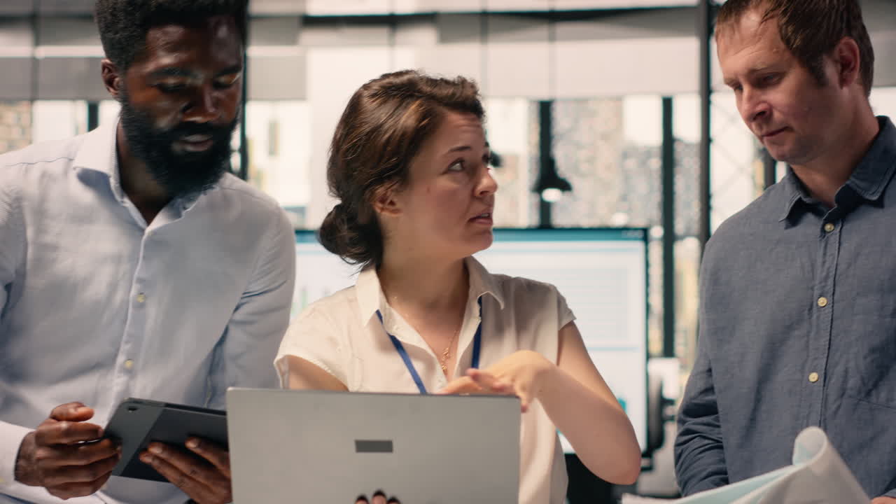 Diverse work team reviewing business intelligence reports and forecasting data
