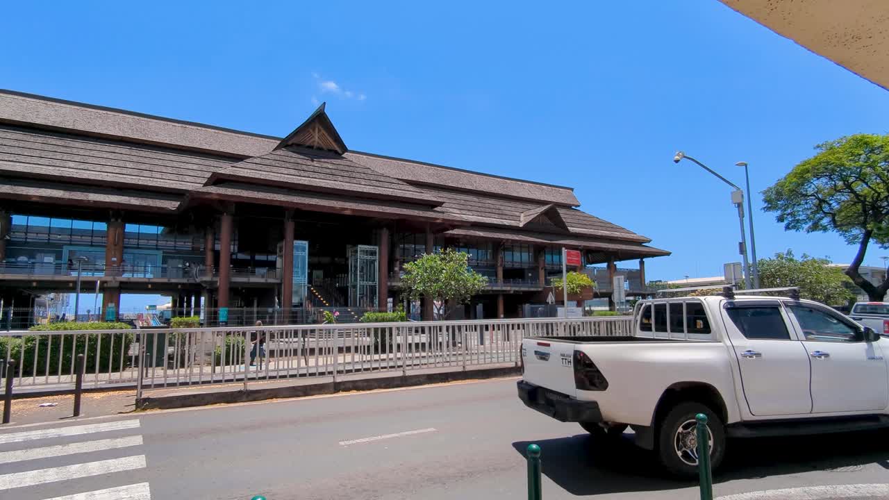 Exterior street view of Papeete port building and inner city traffic on waterfront road in Papeete, Tahiti, French Polynesia