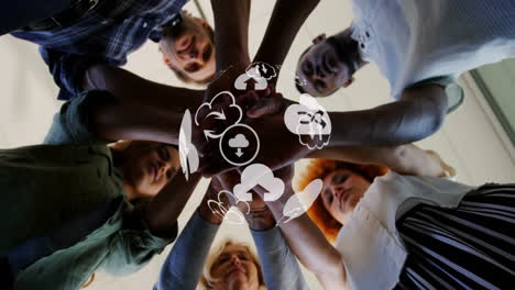 animation of globe with cloud icons over diverse business people stacking hands